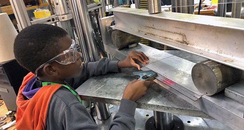 A student works on a mechanical fatigue test