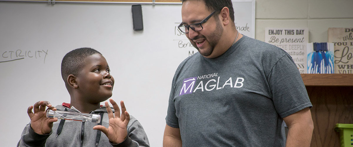 Student performing an experiment with MagLab Staff