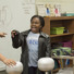 Carlos R. Villa helps students explore static electricity using a Van de Graaff generator during a visit to a local school.