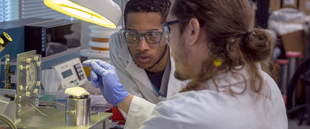 College students performing experiments in the REU program