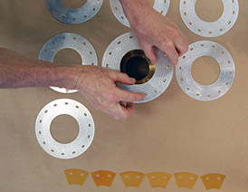 Stacking Bitter plates into a magnet coil.