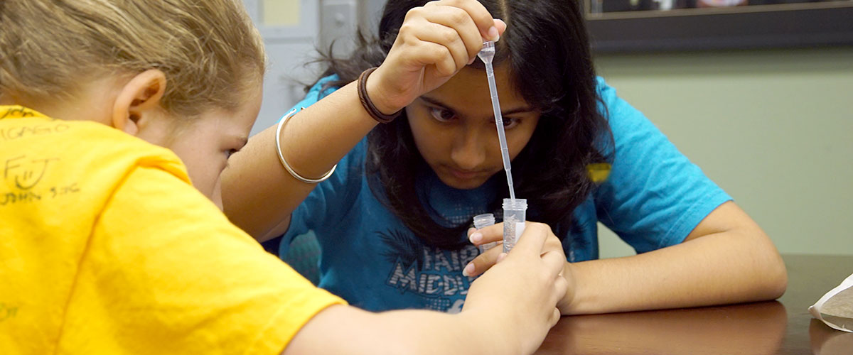 Camp TESLA attendees running a DNA experiment