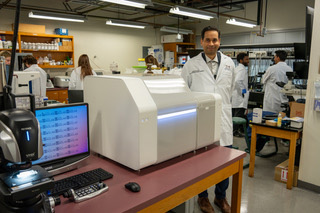 FAMU-FSU engineering assistant professor Jamel Ali inside his lab alongside the new 3D printer.