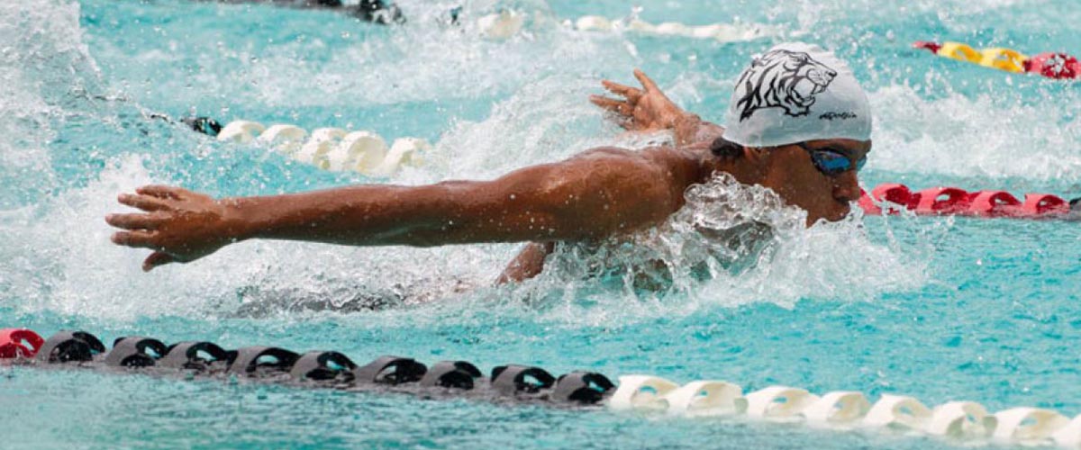 The demands of competitive swimming prepared lab assistant Christopher Reis well for a science career.