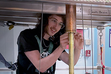 Graduate Student performing maintenance on a High B/T Magnet